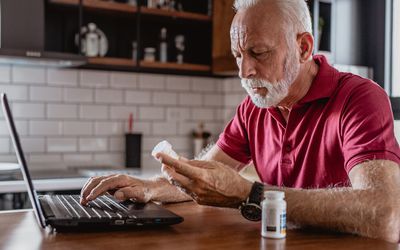 Man reading about medicine online