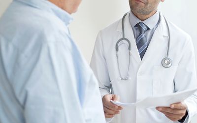 Male doctor holding medical notes