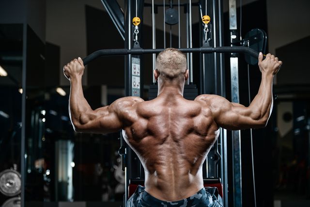 Brutal strong bodybuilder athletic men pumping up muscles with dumbbells